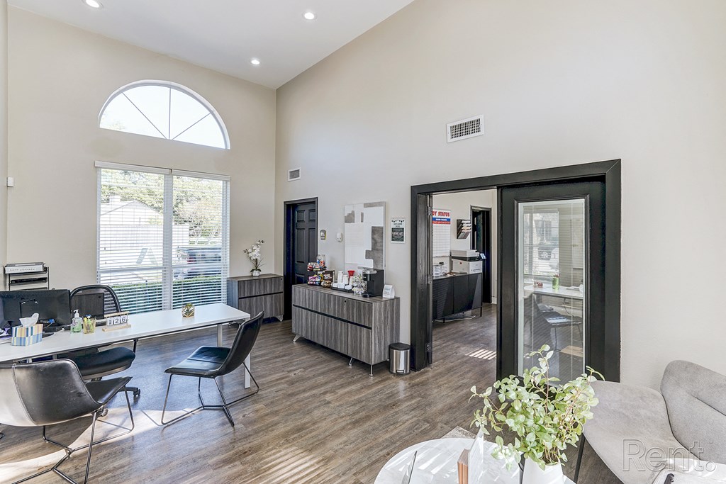 an office with a table and chairs and a large window