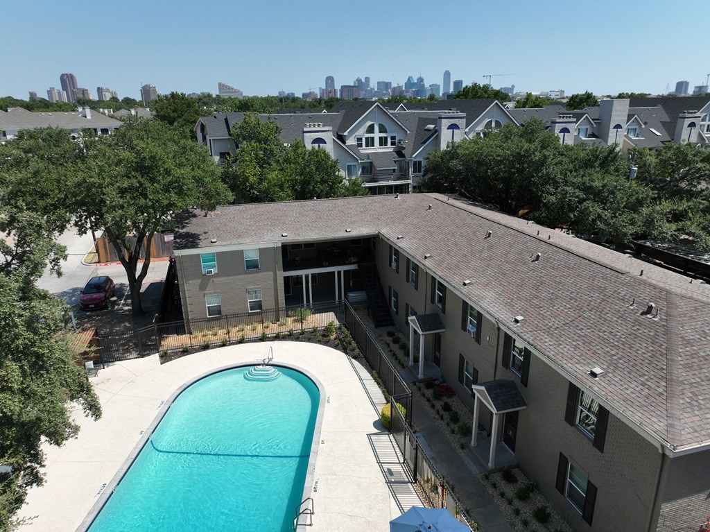 an aerial view of an apartment building with a swimming pool