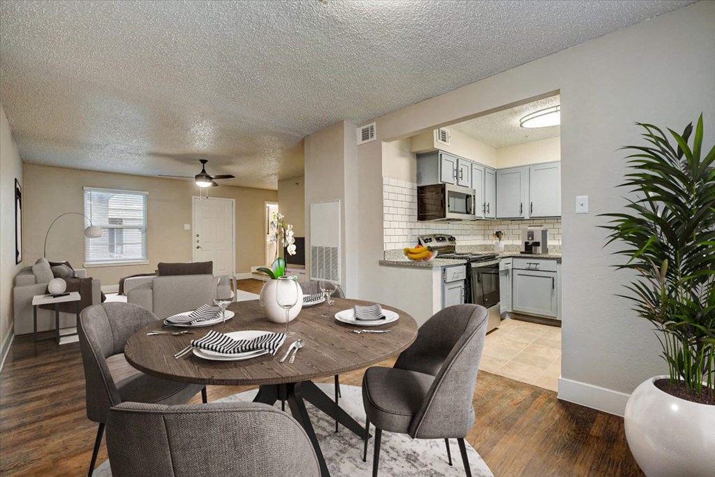 an open kitchen and dining area with a table and chairs