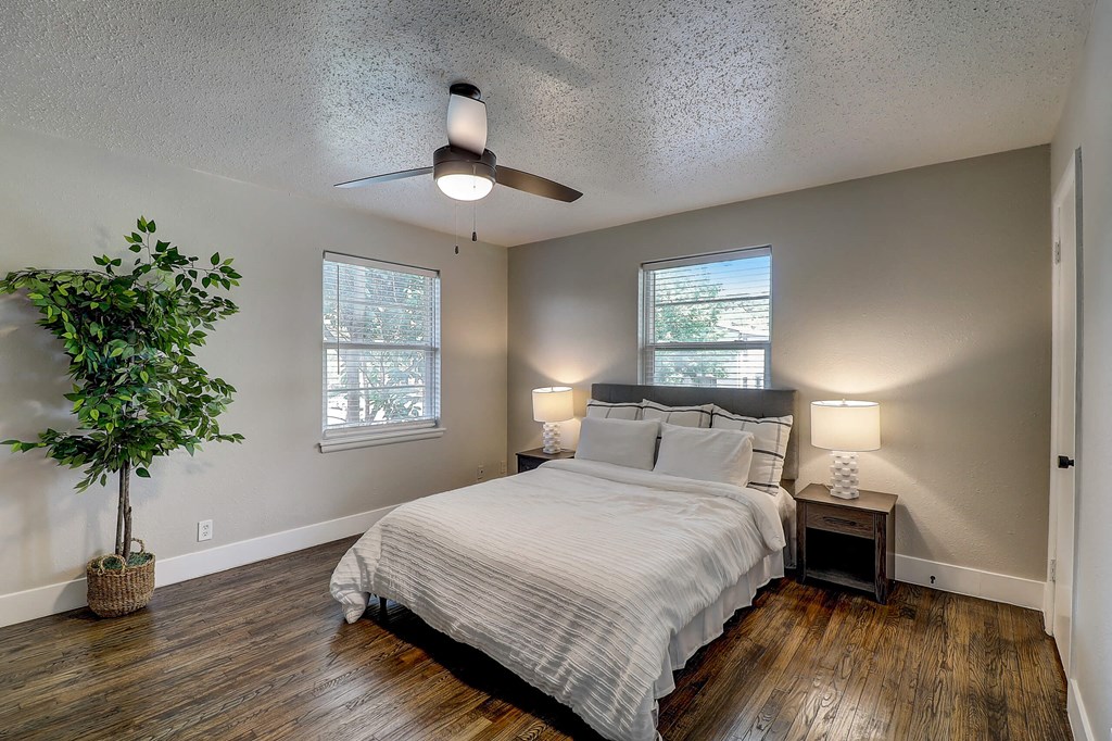 a bedroom with a bed and a ceiling fan