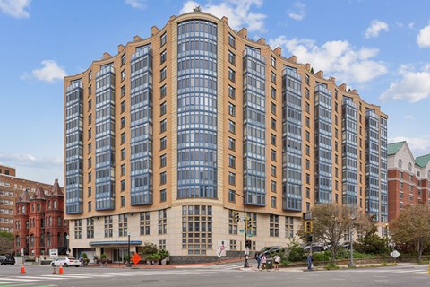 A large building with many windows is in the foreground.
