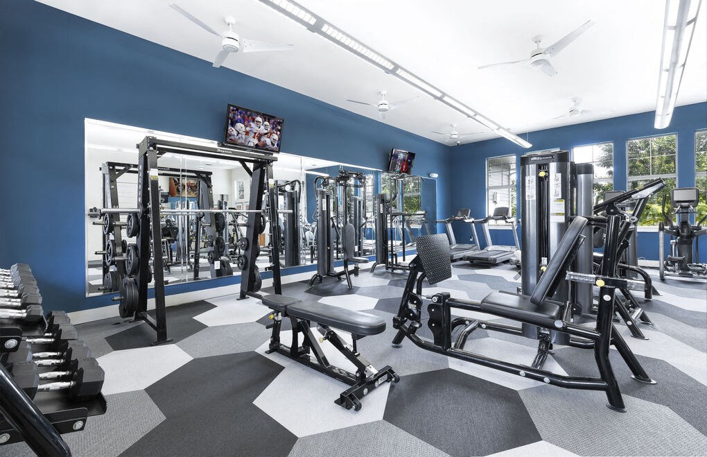 a workout room with exercise equipment and a flat screen tv