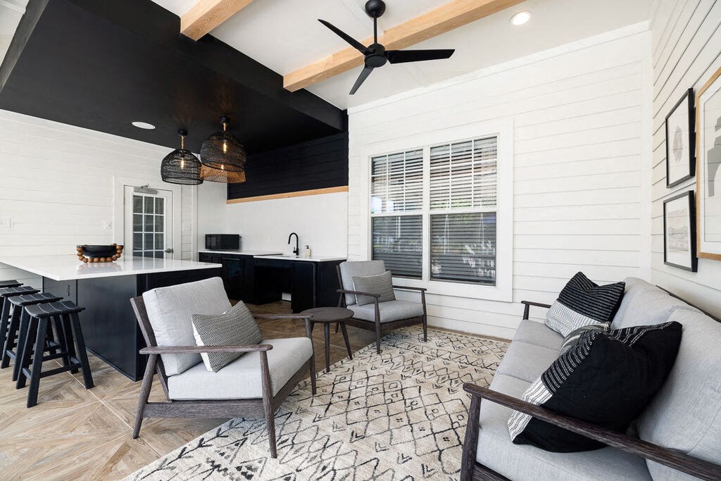 a living room with white walls and a black ceiling
