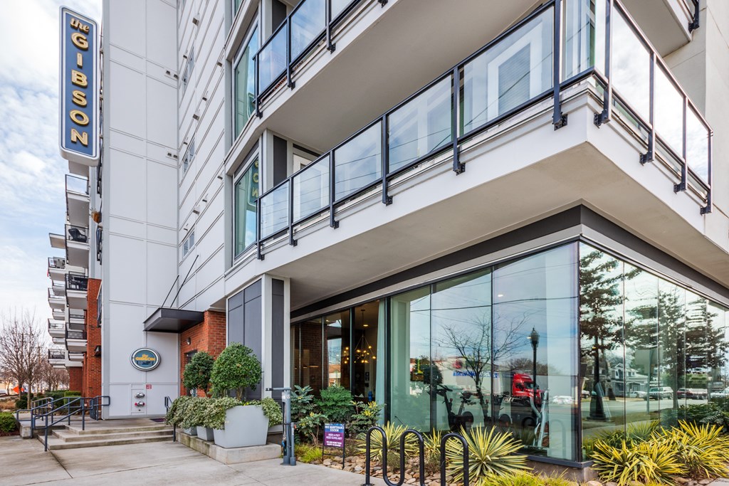 a large building with glass windows and a patio in front of it