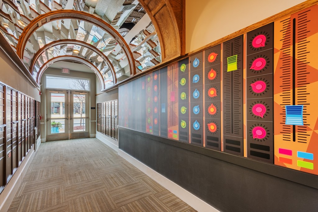 the lobby of a building with a large wall of colorful artwork