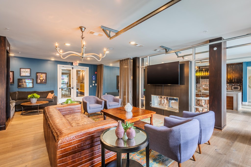 a living room with a couch and chairs and a television