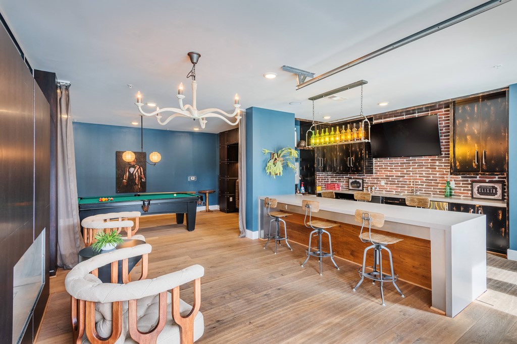 a game room with a pool table and bar