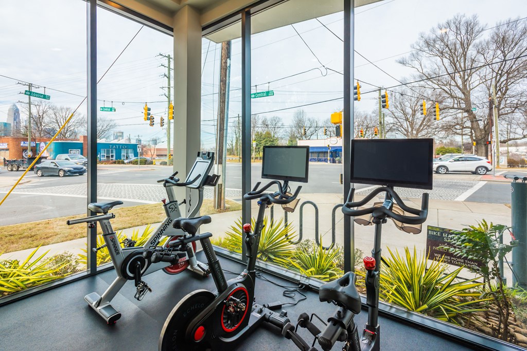 a group of exercise bikes in a gym window