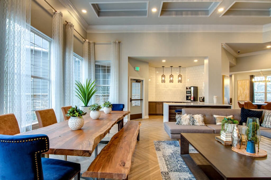 a large living room with a long wooden table and chairs