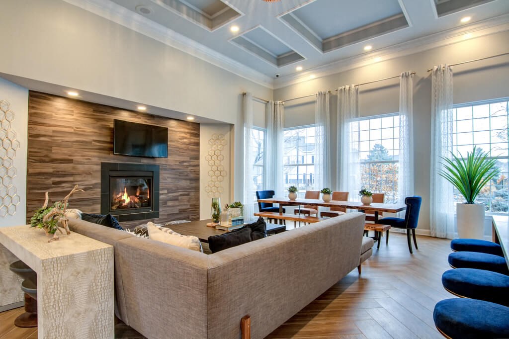a living room with a fireplace and a dining room in the background