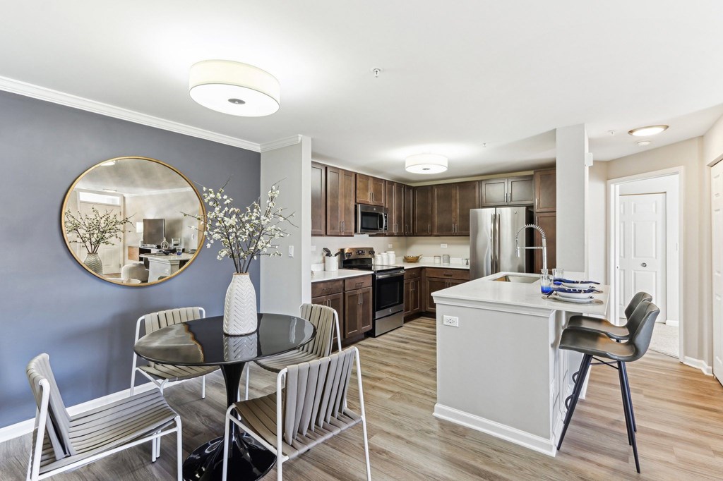 A modern kitchen with a dining table and chairs.