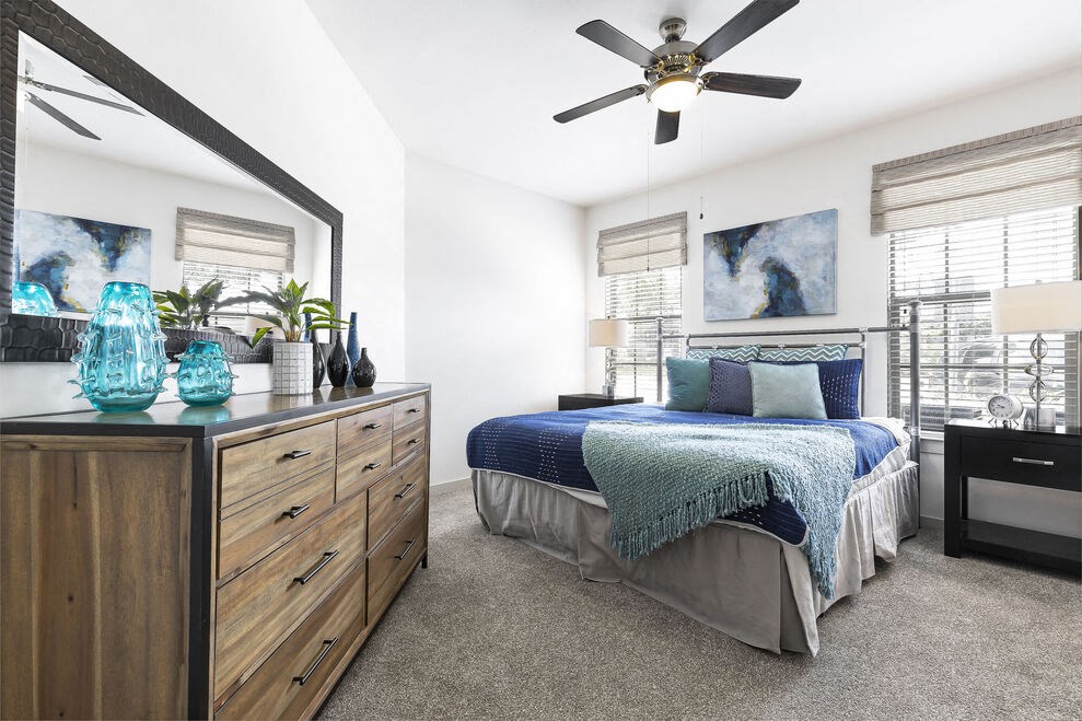 a bedroom with a bed and a ceiling fan