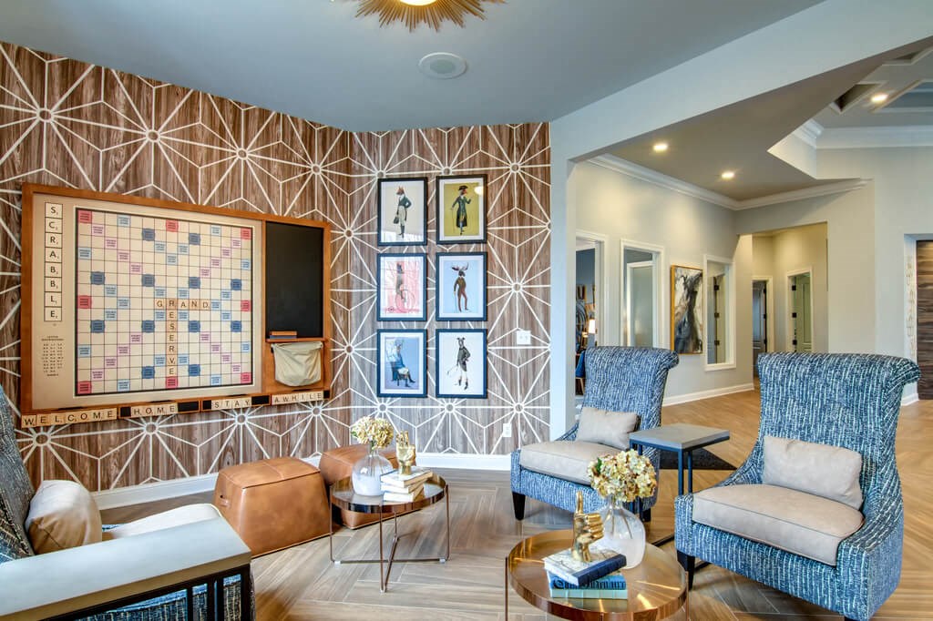 a living room with a large screen tv on the wall