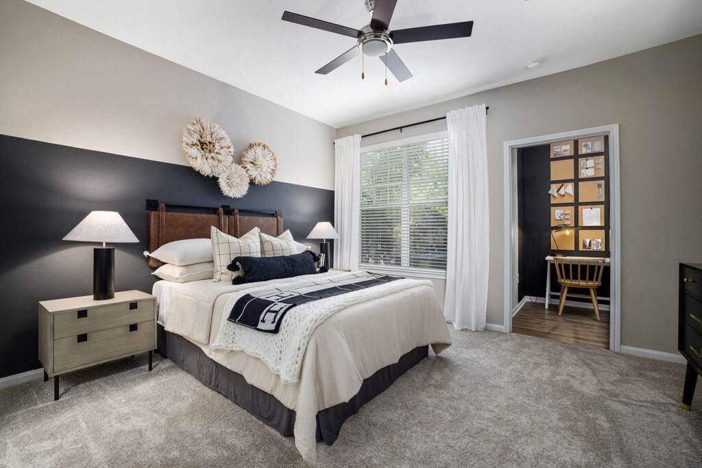 a bedroom with a bed and a ceiling fan a bedroom with a bed and a ceiling fan at Tradition at Stonewater, Cary, NC, 27519