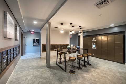 a long table with stools in the lobby of a building