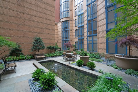 A courtyard with a fountain and a bench.