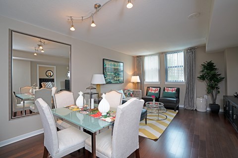 A dining room with a glass table and chairs.