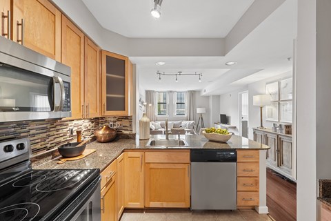 A modern kitchen with wooden cabinets and stainless steel appliances.
