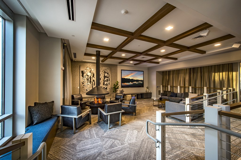 a large community lounge filled with furniture and a large window