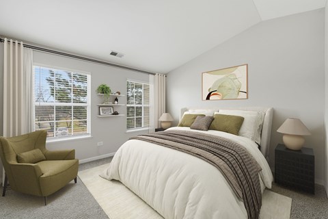 A bedroom with a large bed and a chair.