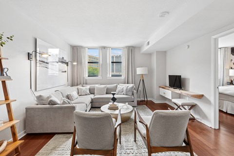 Furnished apartment living room with large windows at The Hayward on Mass Ave in Washington, DC