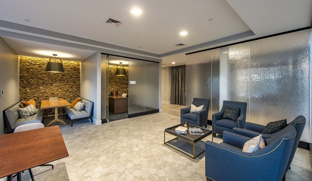 a room with a couch and a table and two work from home nooks