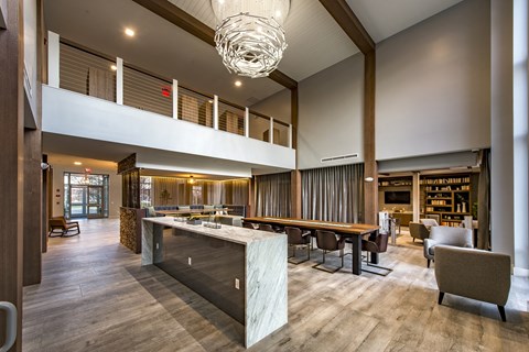 a large open space with a large table and chairs and a high ceiling with a chandel