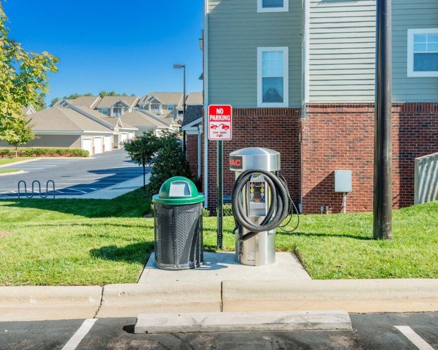 a couple of trash cans sitting in front of a house