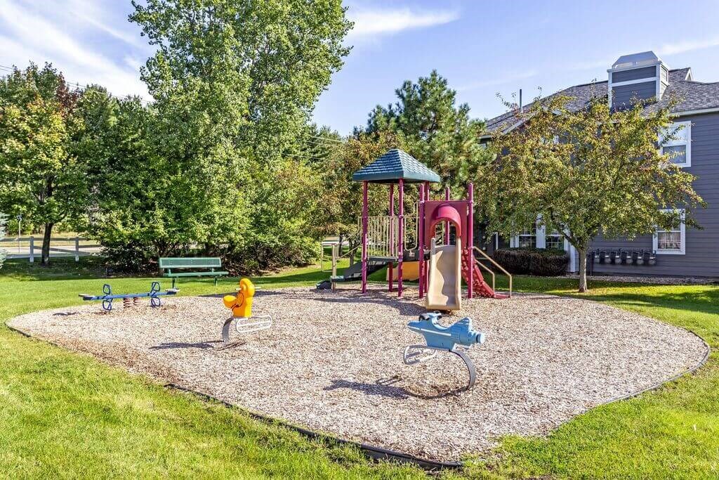 a park with a playground and a house in the background