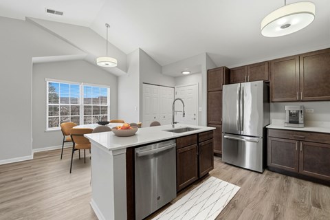 A modern kitchen with a dining table and chairs.