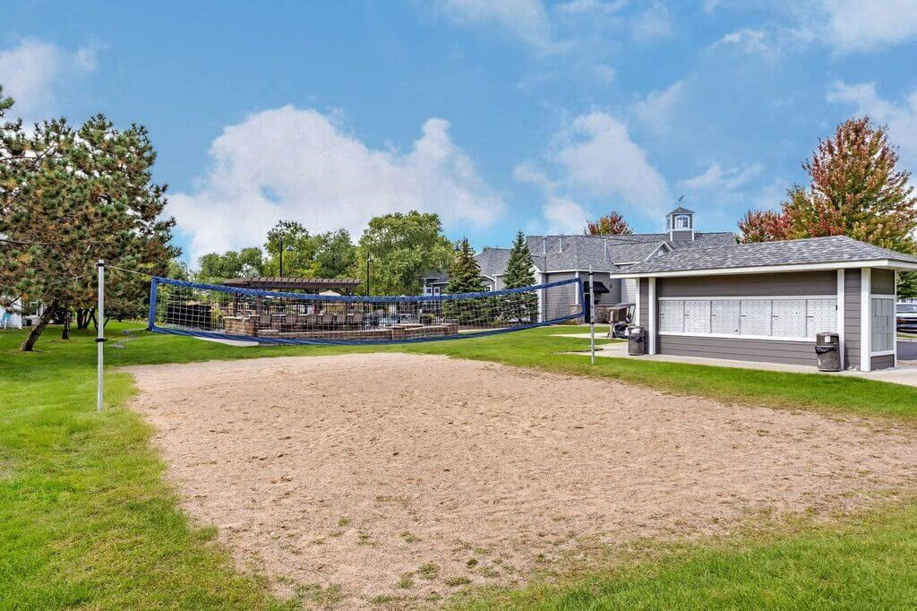a house with a volleyball court in front of it