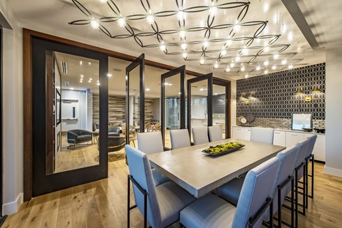 a conference room with a long table and white chairs
