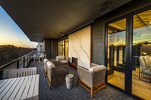 a large balcony with a seating area and a dining table