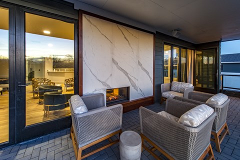 outdoor balcony with fireplace and seating area