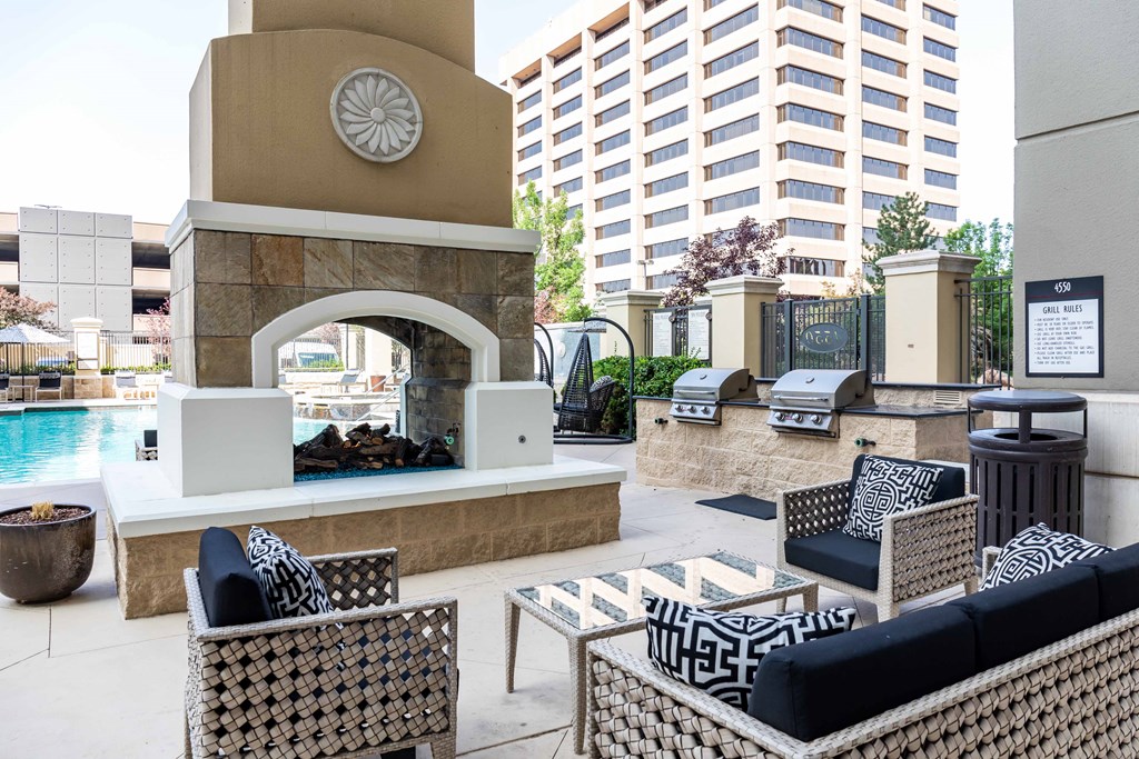 A patio with a fireplace and seating area.