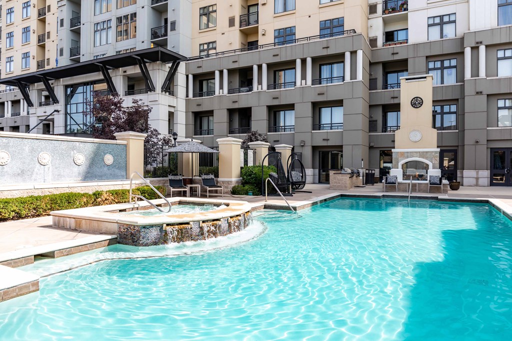 A large swimming pool in front of a building.