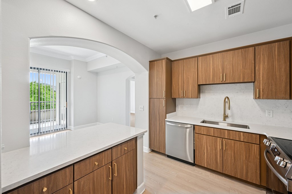 A kitchen with wooden cabinets and a white countertop.