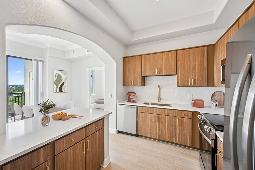 A kitchen with wooden cabinets and a white countertop.