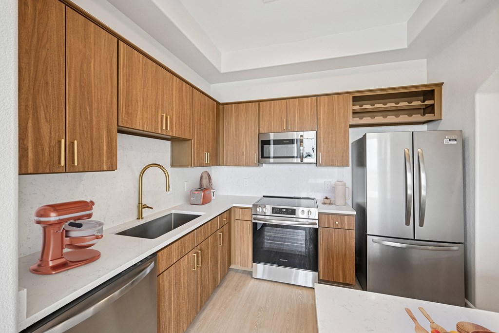 A kitchen with wooden cabinets and stainless steel appliances.