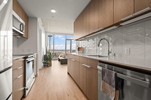A modern kitchen with wooden cabinets and stainless steel appliances.