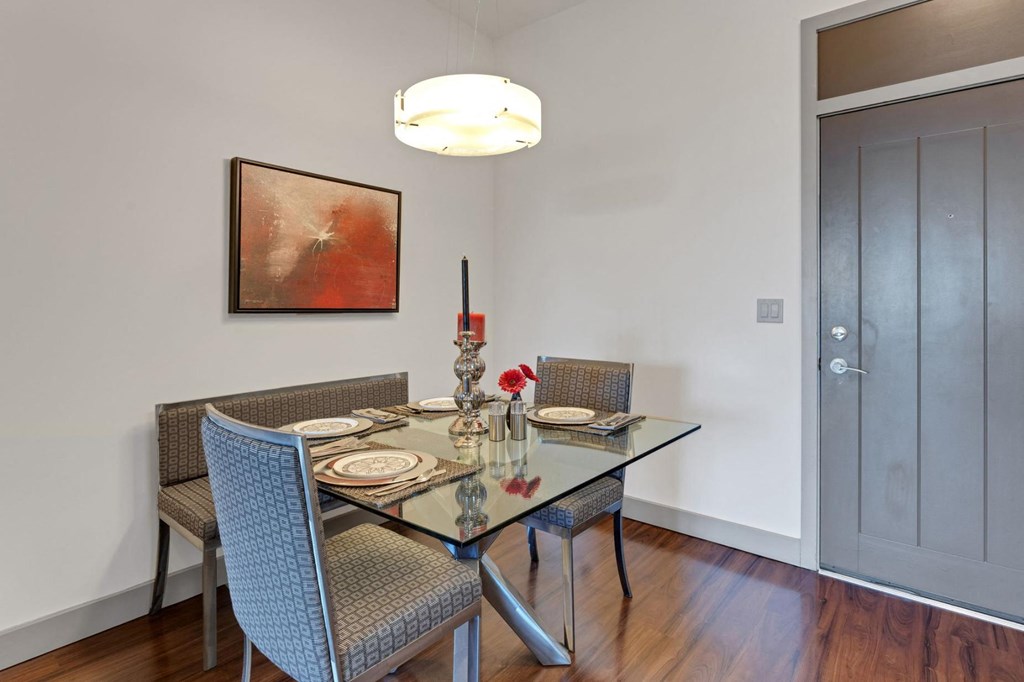 a dining room with a glass table and chairs