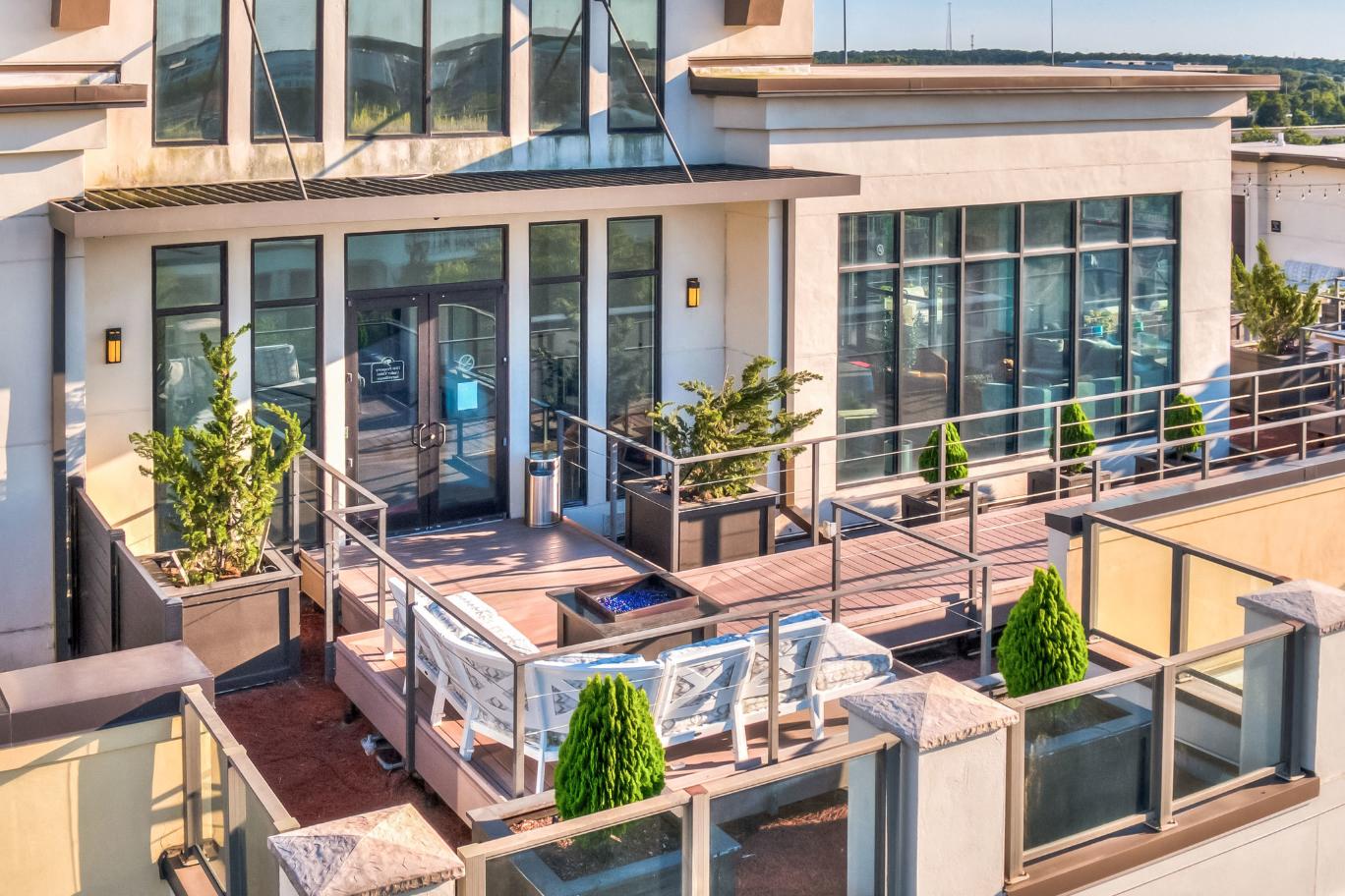a patio with a table and chairs in front of a building