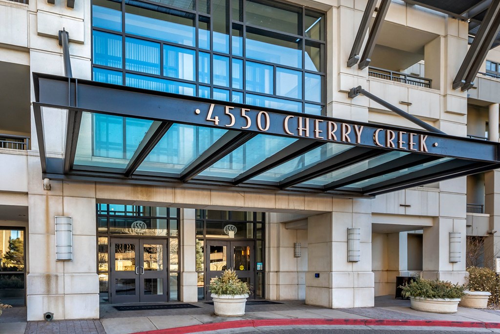 The front of the Cherry Creek building is shown with the entrance and the name of the building.