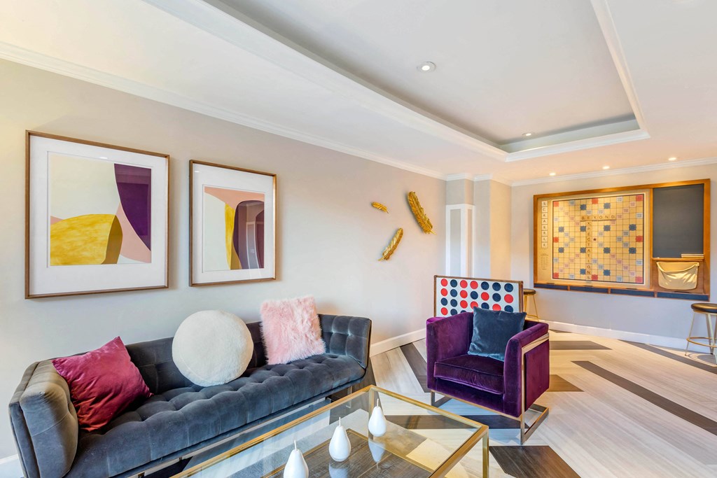 A living room with a grey couch and a purple chair.