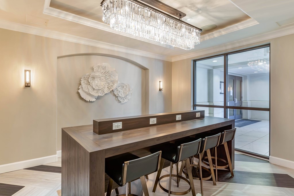 A dining room with a wooden table and chairs.