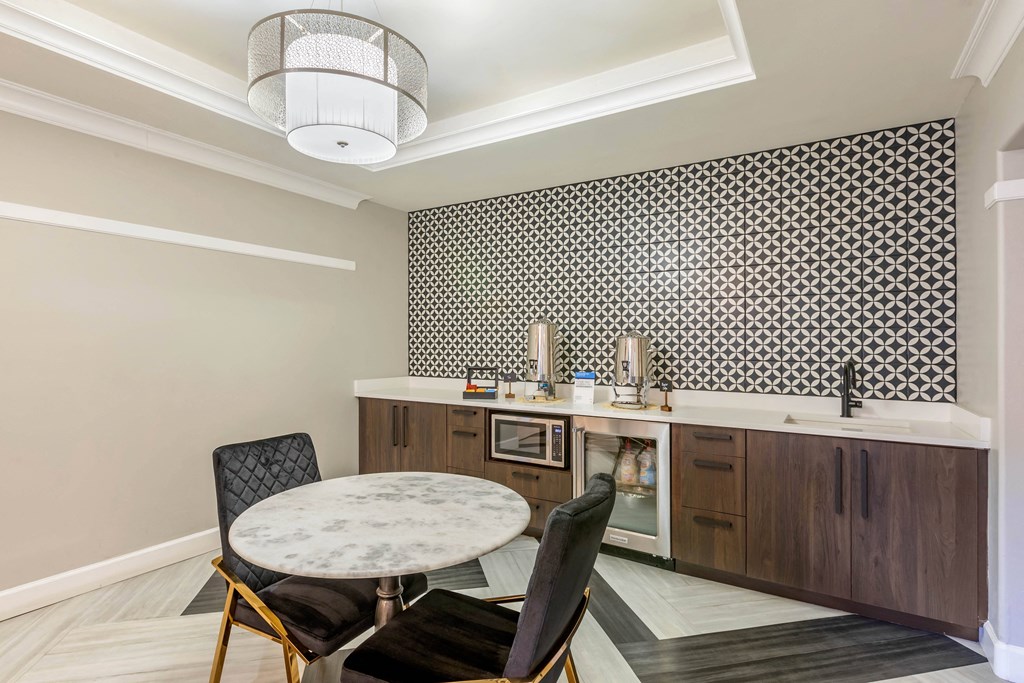 A kitchen with a round table and chairs.