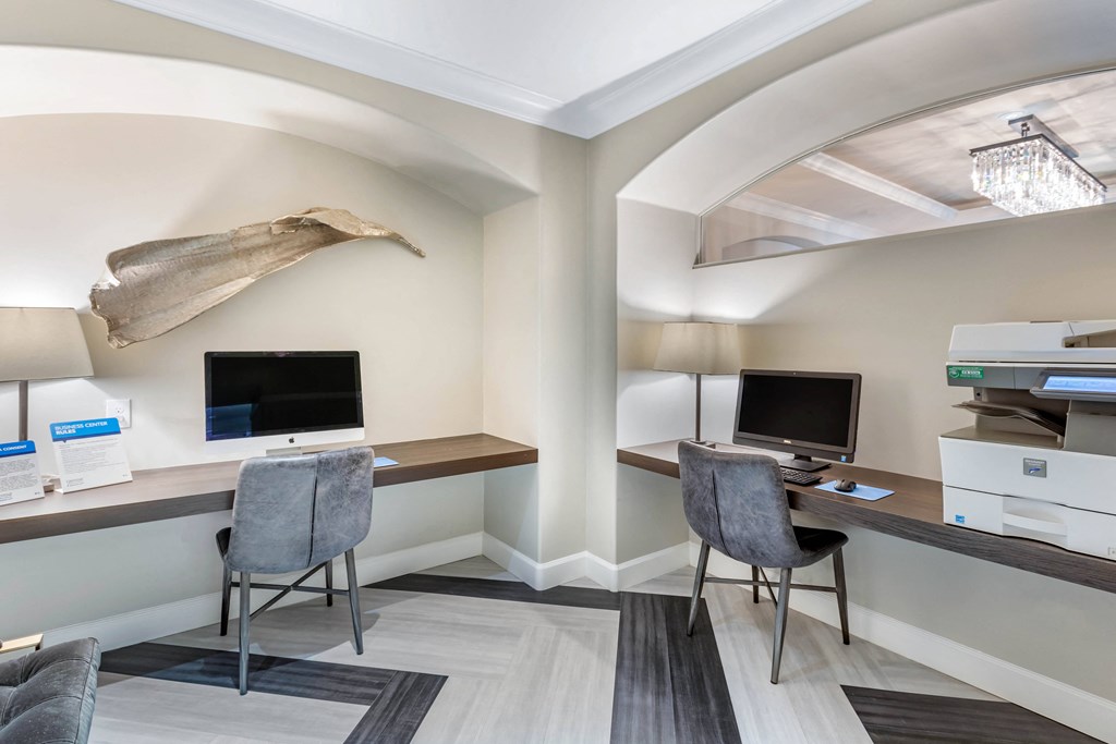 A modern office with two desks and chairs.