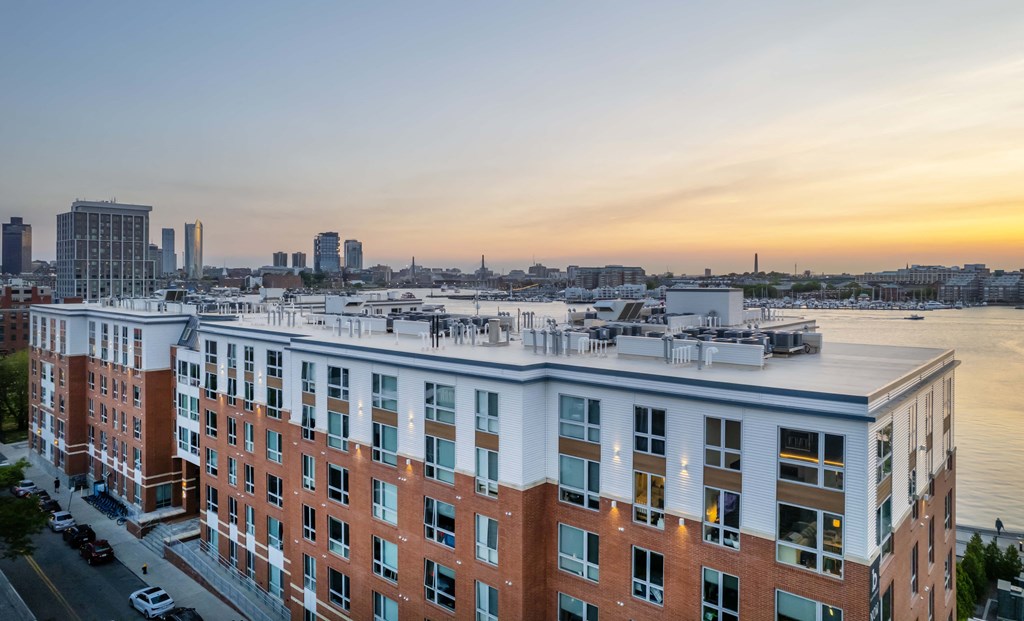 an aerial view of a building with a city in the background
