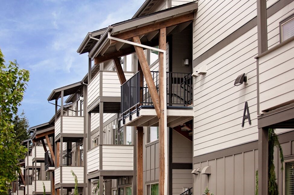 a view of a building with a balcony and a blue sky in the background