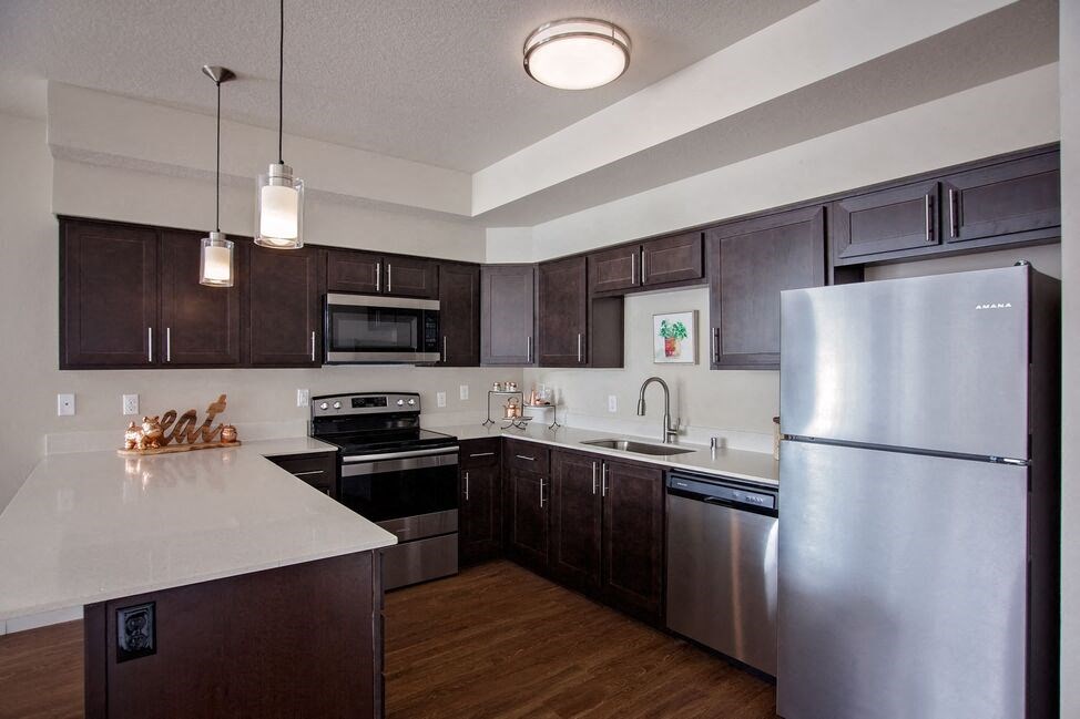 a kitchen with stainless steel appliances and a white counter top